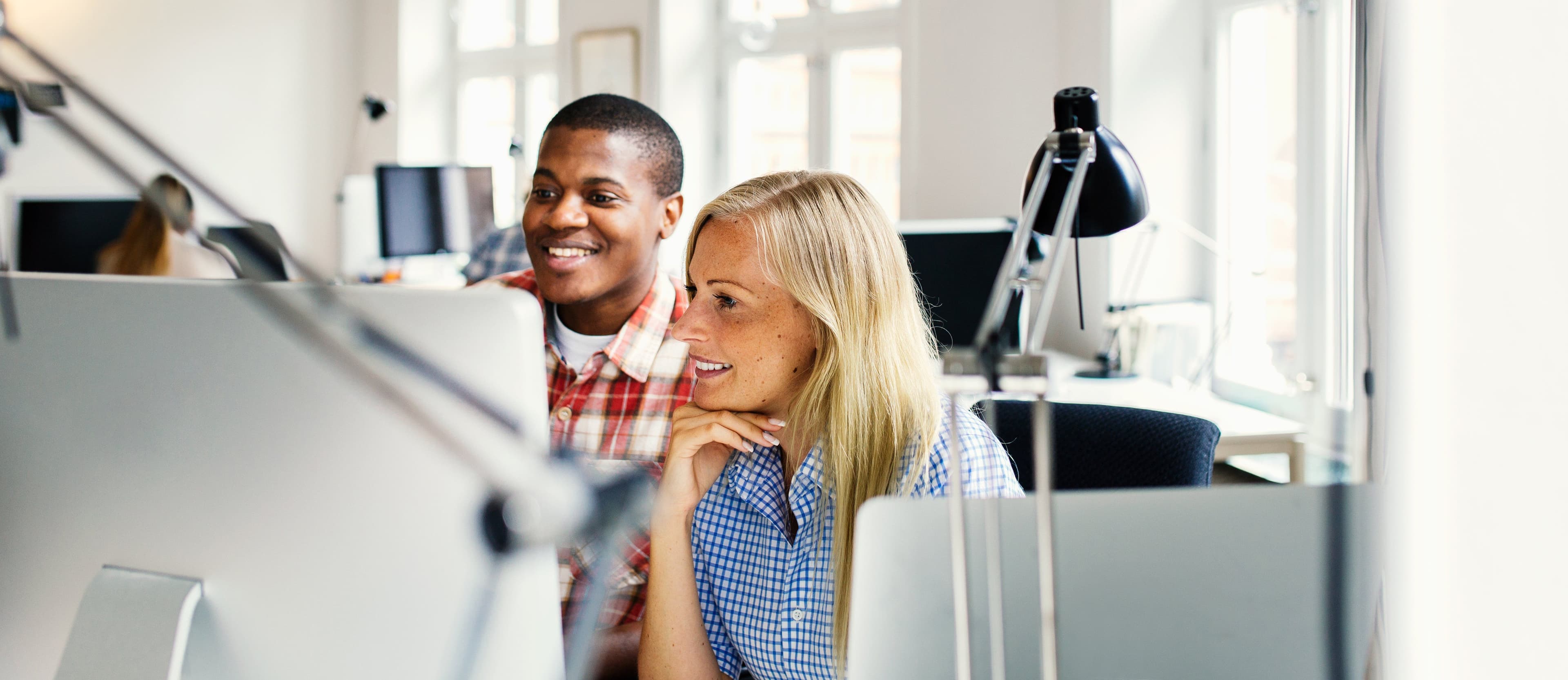editors-using-computer-together-in-office-2024-10-17-21-30-54-utc.jpg