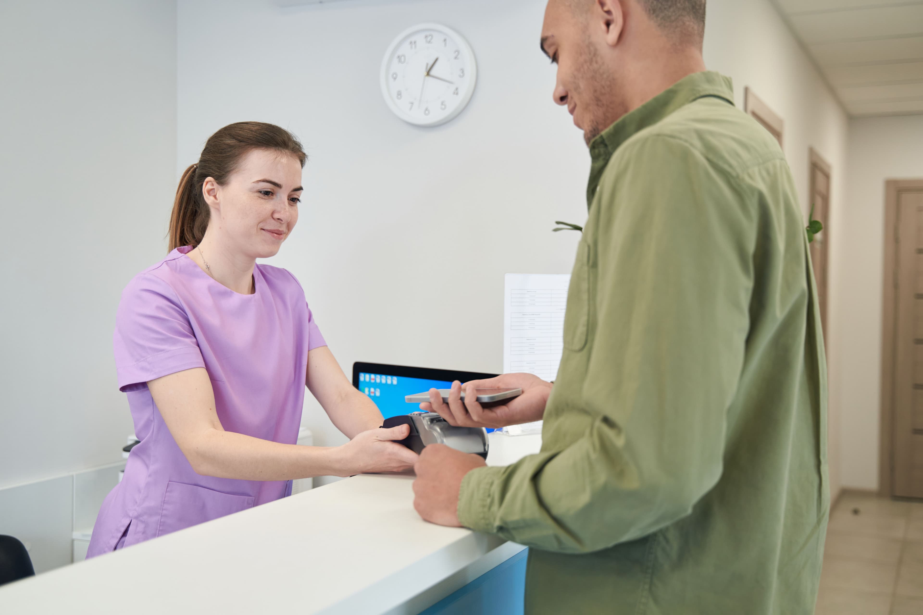 male-client-paying-for-clinic-services-with-smartp-2024-10-20-16-20-03-utc.jpg